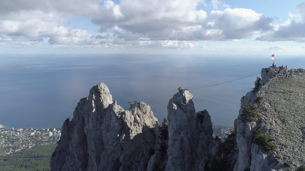 Peaceful meadow and view of the city from the mountain against the sea. Aerial of the marine landscape