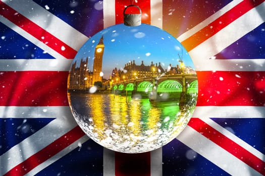London landmarks evening snow view through glass christmass ball on UK flag, xmas time in London concept