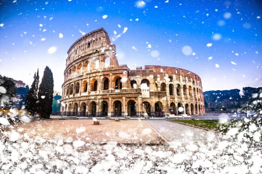 Colosseum of Rome dawn snow view, famous landmark of eternal city winter view, capital of Italy