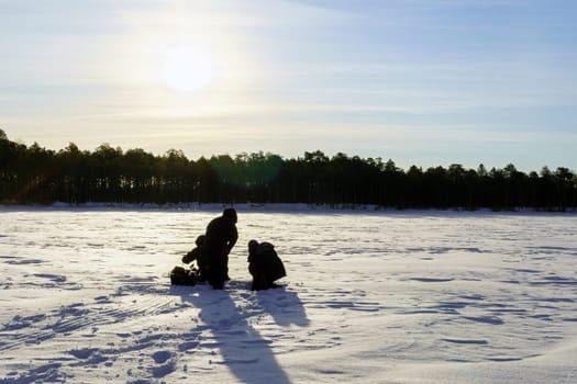 People Enjoying Winter Fishing. Winter activity. Copy space