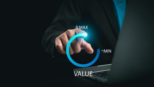 Businessman is pulling up circle progress bar with the word VALUE on dark tone background, value added or business growth concept, increase value, Growth value.