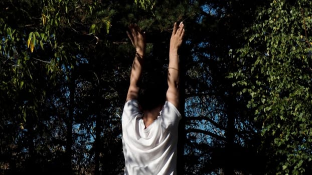 Relaxing woman in a summer forest. Motion. Sports activities outdoors on a sunny day