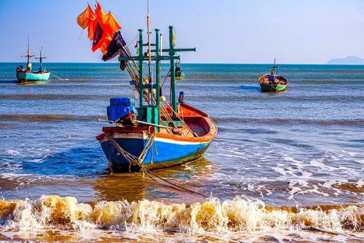 Vibrant Reflections Traditional Fishing Boat at the Shores of Thailand