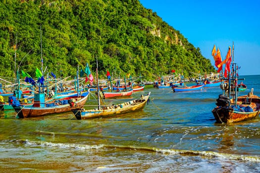 Vibrant Reflections Traditional Fishing Boat at the Shores of Thailand