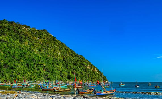 Vibrant Reflections Traditional Fishing Boat at the Shores of Thailand