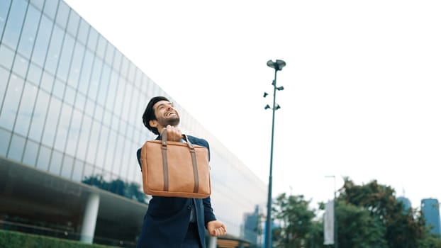 Successful business man celebrate increasing sales while standing. Happy project manager or leader proud with successful project, getting a promotion, getting a job. Overjoy and happy. Exultant.