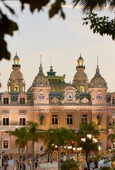 Monaco, Monte-Carlo, 21 October 2022: Square Casino Monte-Carlo at sunny day, a lot of luxury cars, Hotel de Paris, wealth life, tourists take pictures of the landmark, pine trees, blue sky, flowers. High quality 4k footage