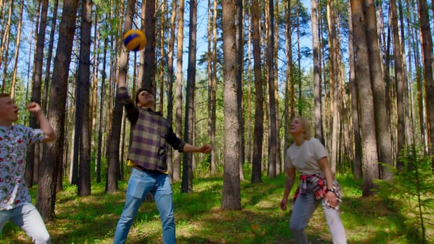 Friends have fun playing volleyball. Stock footage. Friends are emotionally playing volleyball. Vivid emotions of people from playing volleyball in nature.