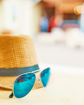 Straw hat on a hot day off with green sunglasses