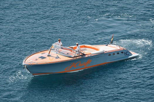 Monaco, Monte Carlo, 27 September 2022 - a boat with guests of yacht brokers departs from the shore in the largest fair exhibition in the world yacht show MYS, port Hercules, rich clients, sunny. High quality photo