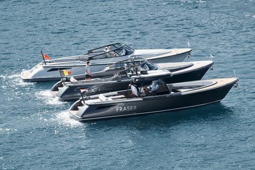 Monaco, Monte Carlo, 27 September 2022 - a boat with guests of yacht brokers departs from the shore in the largest fair exhibition in the world yacht show MYS, port Hercules, rich clients, sunny. High quality photo