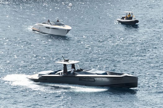 Monaco, Monte Carlo, 27 September 2022 - a boat with guests of yacht brokers departs from the shore in the largest fair exhibition in the world yacht show MYS, port Hercules, rich clients, sunny. High quality photo