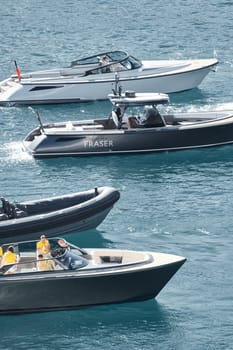 Monaco, Monte Carlo, 27 September 2022 - a boat with guests of yacht brokers departs from the shore in the largest fair exhibition in the world yacht show MYS, port Hercules, rich clients, sunny. High quality photo