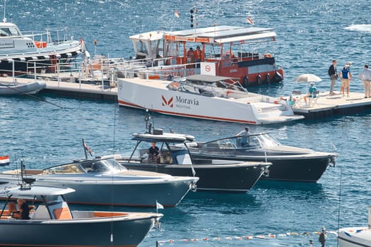 Monaco, Monte Carlo, 27 September 2022 - a boat with guests of yacht brokers departs from the shore in the largest fair exhibition in the world yacht show MYS, port Hercules, rich clients, sunny. High quality photo