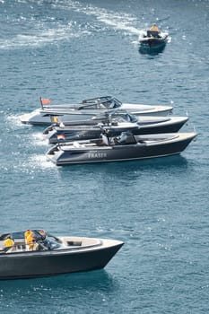 Monaco, Monte Carlo, 27 September 2022 - a boat with guests of yacht brokers departs from the shore in the largest fair exhibition in the world yacht show MYS, port Hercules, rich clients, sunny. High quality photo