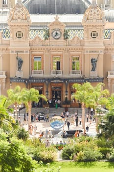 Monaco, Monte-Carlo, 21 October 2022 - Square Casino Monte-Carlo at sunny day, wealth life, tourists take pictures of the landmark, pine trees, blue sky. High quality photo
