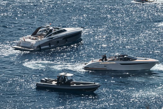 Monaco, Monte Carlo, 27 September 2022 - a boat with guests of yacht brokers departs from the shore in the largest fair exhibition in the world yacht show MYS, port Hercules, rich clients, sunny. High quality photo