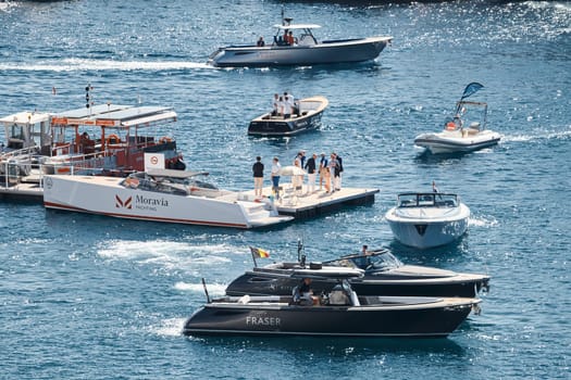 Monaco, Monte Carlo, 27 September 2022 - a boat with guests of yacht brokers departs from the shore in the largest fair exhibition in the world yacht show MYS, port Hercules, rich clients, sunny. High quality photo
