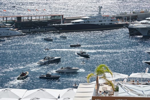 Monaco, Monte Carlo, 27 September 2022 - a boat with guests of yacht brokers departs from the shore in the largest fair exhibition in the world yacht show MYS, port Hercules, rich clients, sunny. High quality photo