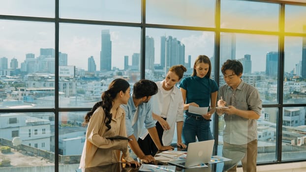 Group of diverse business people brainstorming about marketing plan. Multicultural business team working, talking, presenting about financial strategy with idea written on glass wall. Tracery