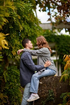 Joyful Autumn Embrace: Cute Lovers Strolling in the Park. Young Cute Female Hugs Boyfriend. In Autumn Outdoor. Lovers Walking in Park. Attractive Funny Couple. Lovestory in Forest. Man and Woman. Cute Lovers in the Park. Family Concept. Happy Couple.