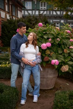 Young Cute Female Hugs Boyfriend. In Autumn Outdoor. Lovers Walking in Park. Attractive Funny Couple. Lovestory in Forest. Man and Woman. Cute Lovers in the Park. Family Concept. Happy Couple.