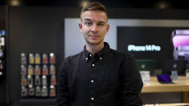 Portrait of young man with raised eyebrow. Action. Expression of young man's face with raised eyebrow. Young man with facial expression in workplace.