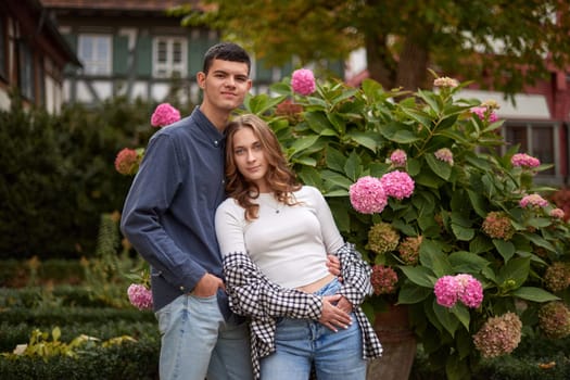 Young Cute Female Hugs Boyfriend. In Autumn Outdoor. Lovers Walking in Park. Attractive Funny Couple. Lovestory in Forest. Man and Woman. Cute Lovers in the Park. Family Concept. Happy Couple.