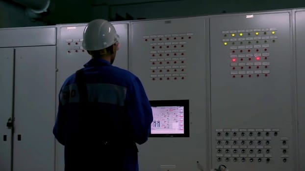 Labor force. Clip. A man in a factory does something for work aimed at production