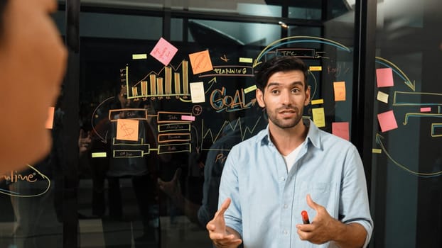 Professional businessman presenting marketing idea or financial plan to smart investor. Executive manager sharing, talking, working together with cooperative colleagues. Business concept. Tracery