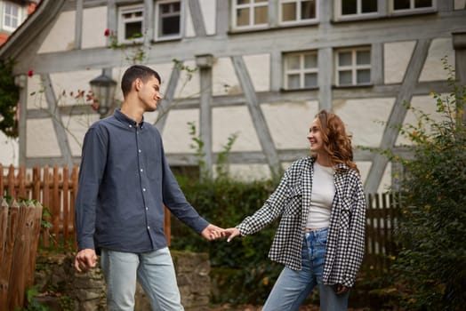 Young Cute Female Hugs Boyfriend. In Autumn Outdoor. Lovers Walking in Park. Attractive Funny Couple. Lovestory in Forest. Man and Woman. Cute Lovers in the Park. Family Concept. Happy Couple.