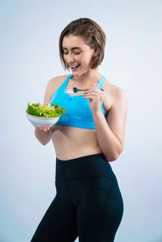 Full body length gaiety shot athletic and sporty young woman with healthy vegan food in standing posture on isolated background. Healthy active and body care by vegetarian lifestyle.