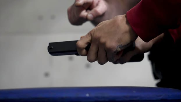 Trainer is teaching man to shoot a gun close up. Close up of male hands with a gun, man trains to shoot. Special police unit in training, school. Military shooting Short Gun.