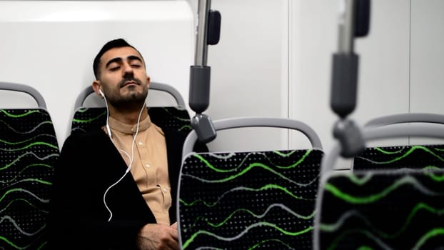 A handsome man dancing in transport. Motion.A stylish businessman who goes to work in an empty bus listening to music with headphones. High quality FullHD footage