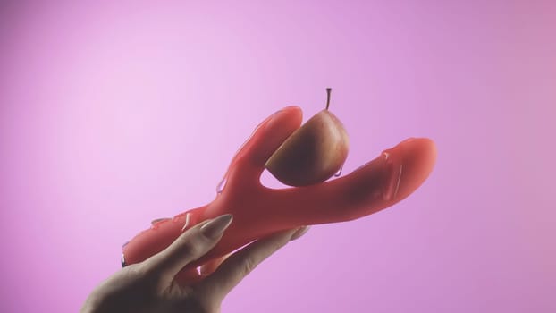 Woman holds sex toy. Creative. Woman's hand holds vaginal sex toy. Vibrator for female satisfaction. Modern types of vibrators and sex toys.