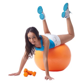 Sporty woman posing while exercising on fitness ball