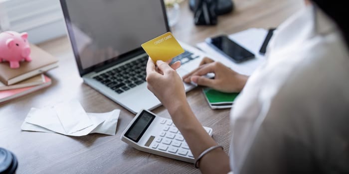 Woman on desk with laptop, credit card and ecommerce payment for online shopping at home. Happy female customer, digital bank app and sale on store website with internet banking.