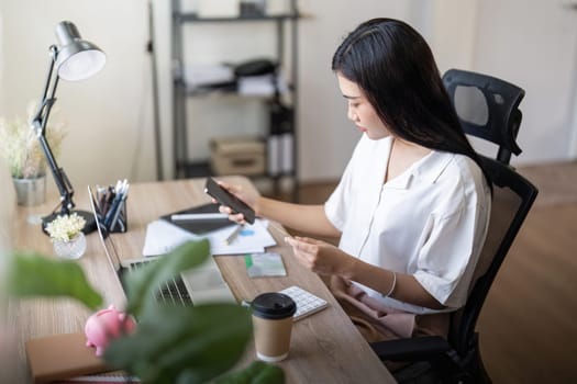 Woman on desk with laptop, credit card and ecommerce payment for online shopping at home. Happy female customer, digital bank app and sale on store website with internet banking.