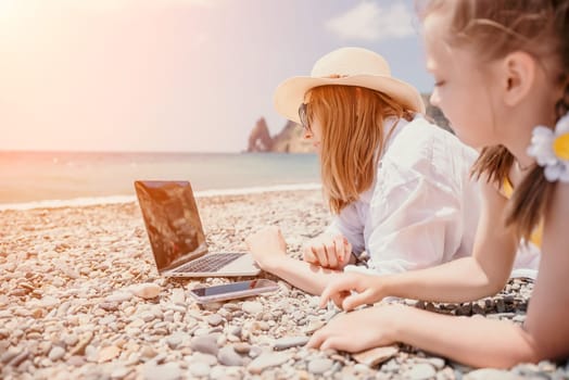 Woman sea laptop. Business woman in yellow hat working on laptop by sea. Close up on hands of pretty lady typing on computer outdoors summer day. Freelance, digital nomad, travel and holidays concept.