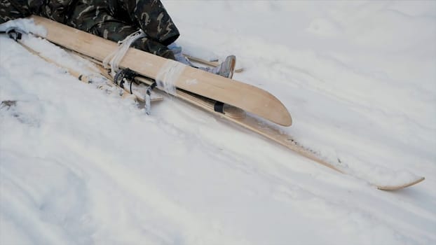 Skier after accident waiting for rescue lying in snow. Clip. Professional skier after crash accident on skiing resort slope - Winter sport emergency concept. Ski patrol team rescue injured skier with the special emergency sledges.