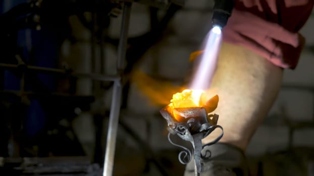 Blacksmith aligns leaves of iron rose and makes the final shape of the flower. Blacksmith makes iron rose.