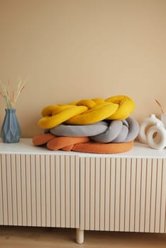 single orange color pillow on a decorative table .