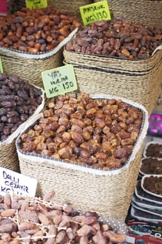 many date fruits display for sale at local market .