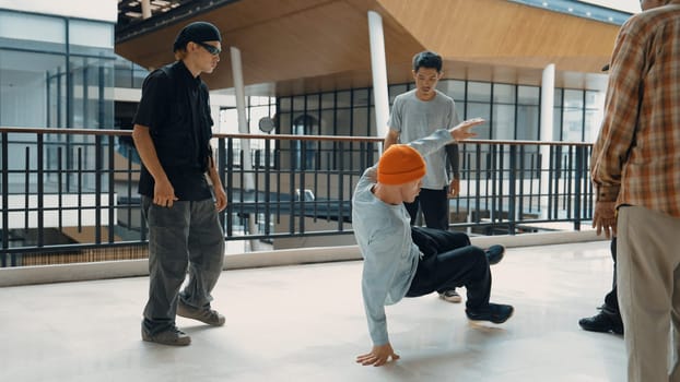 Hip hop team dance break dance while multicultural friend surrounded and clapping hands to cheer or encourage his friend to dance. Active and energetic street dance. Outdoor sport 2024. Endeavor.