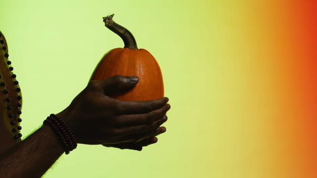 Man gives fruit from hand to hand. Stock. The concept of trade. Black guy gives fruit to white man.