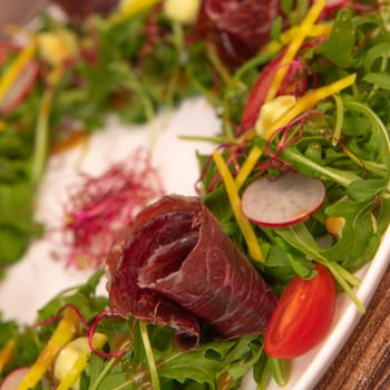 Tasty salad ham with fresh vegetables on wooden background, High quality photo