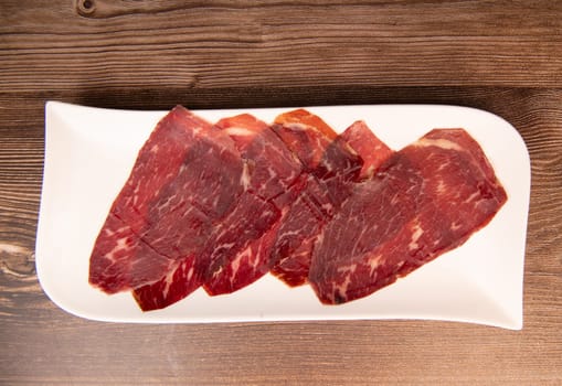 Dry-cured Spanish ham, Serrano ham, Bellota ham, Italian prosciutto crudo or Parma ham, wagyu slice. High quality photo