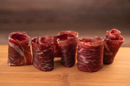 Dry-cured Spanish ham, Serrano ham, Bellota ham, Italian prosciutto crudo or Parma ham, wagyu slice. High quality photo