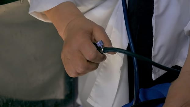 Blood pressure check close up. Clip. A man in white shirt measuring blood pressure with a tonometer, concept of medicine