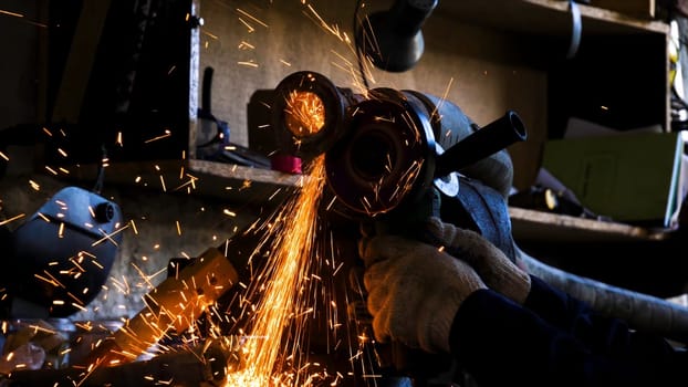 Close-up of worker cutting metal with grinder. Frame. Sparks while grinding iron. Circular cutting disc cuts of metal.